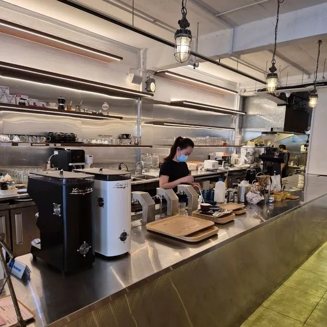 A barista pulling a shot at the espresso machine