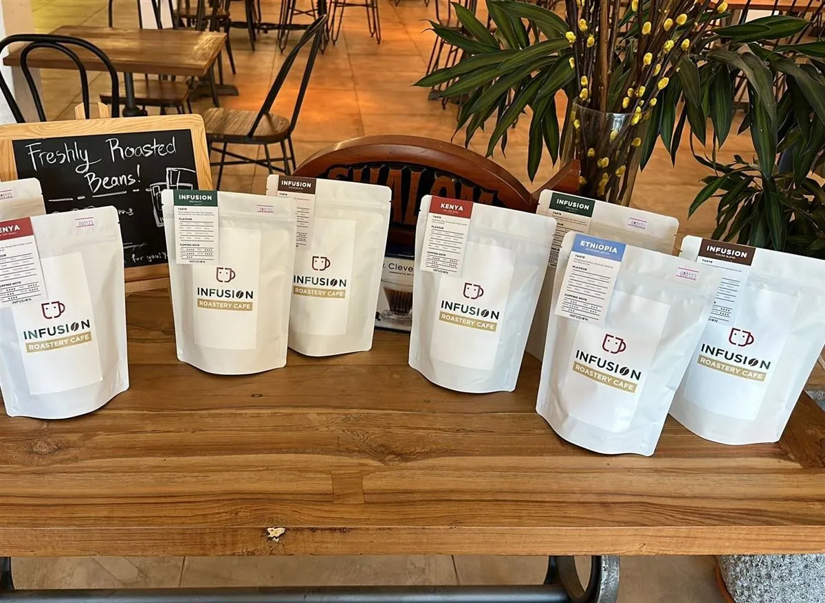 Bags of house-roasted Infusion coffee beans on a shelf