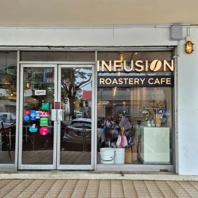 The Infusion Roastery Cafe shopfront — gold lettering on glass, on the ground-floor walkway of ICB Shopping Centre